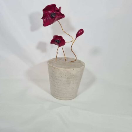 Red Wire Flowers In A Concrete Base